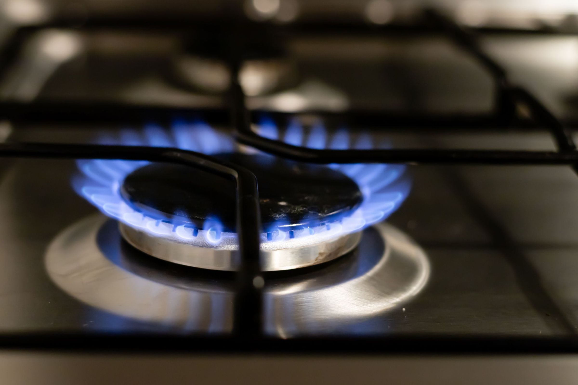 Lit gas burner on a cooktop grate